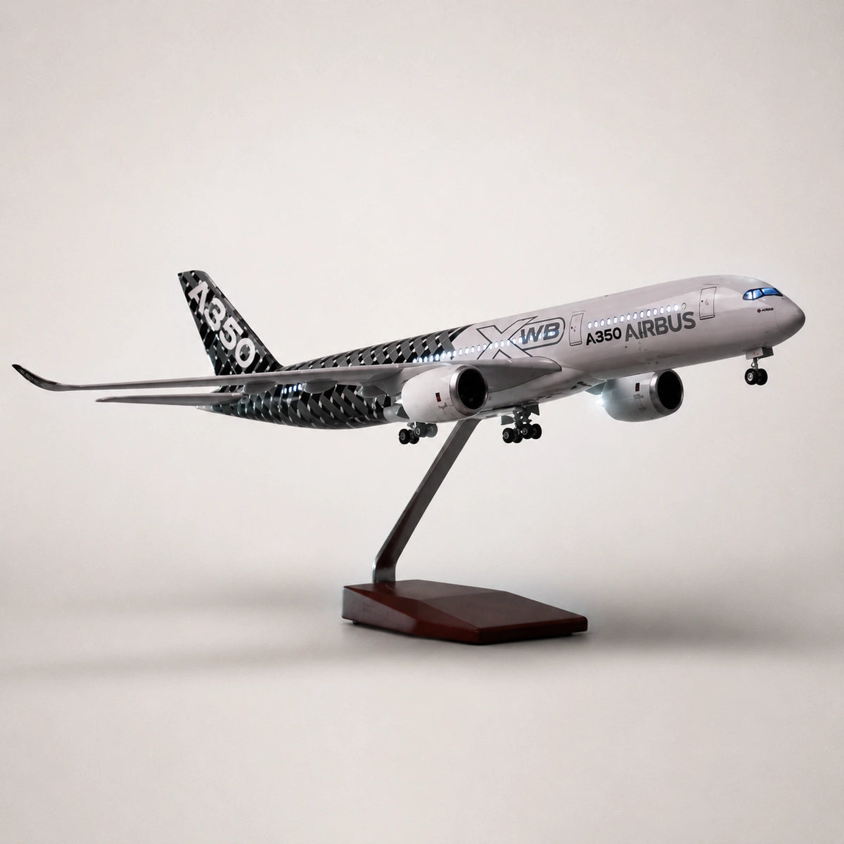 Prototype Airbus A350 XWB Carbon 1:142 scale airplane model with realistic LED cabin lighting displayed on premium wooden stand.